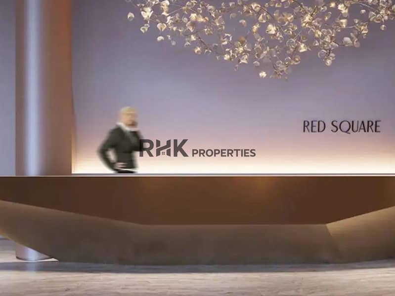 6 Red Square Dubai grand lobby reception with sculptural bronze desk and gold botanical chandelier installation