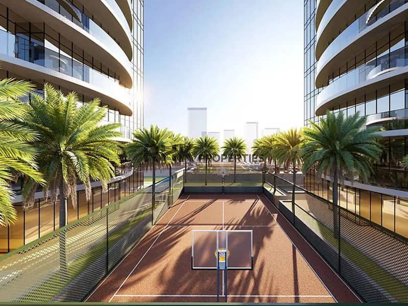 8 Outdoor sports court with basketball hoop and palm trees between twin glazed towers at Red Square Dubai
