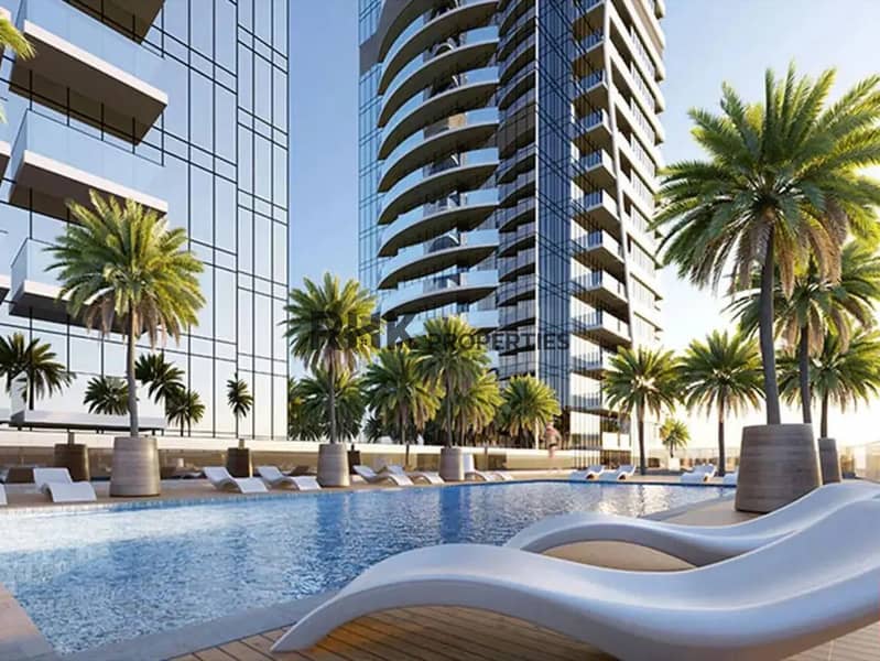 10 Outdoor infinity pool with curved sunbeds, palm trees and high-rise tower views at Red Square Dubai