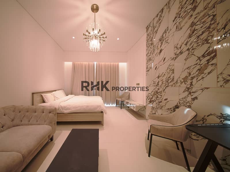 Luxury master bedroom in Dubai villa with marble feature wall, crystal chandelier, tufted sofa, and double-height ceilings Luxury master bedroom in Dubai villa with marble feature wall, crystal chandelier, tufted sofa, and double-height ceilings
