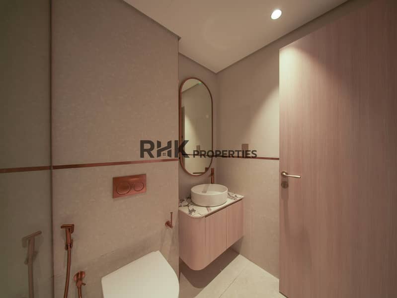 10 Modern studio apartment bathroom with vanity sink, designer mirror, and premium finishes in Dubai