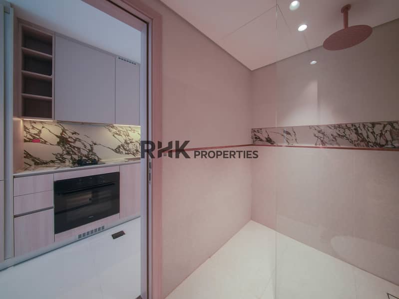 12 Studio apartment bathroom with spacious walk-in shower and adjacent fully fitted kitchenette