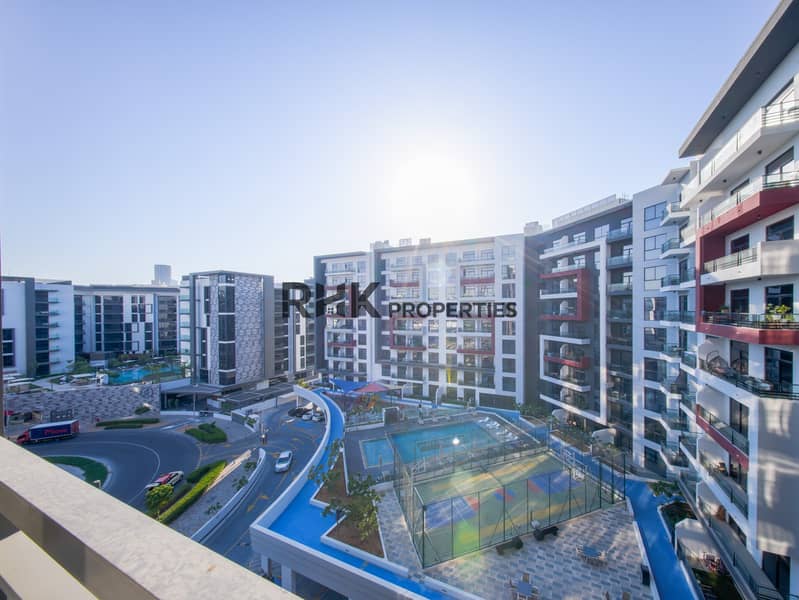 14 Private balcony overlooking Dubai residential community with modern apartment buildings and open views