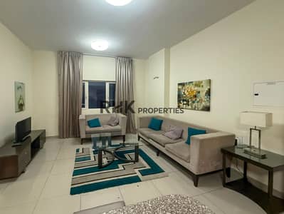1 Bedroom Flat for Rent in Downtown Jebel Ali, Dubai - Spacious furnished living room grey sofas teal cushions Suburbia B Jebel Ali 1 Bedroom Flat for Rent in Downtown Jebel Ali, Dubai - Spacious furnished living room grey sofas teal cushions Suburbia B Jebel Ali
