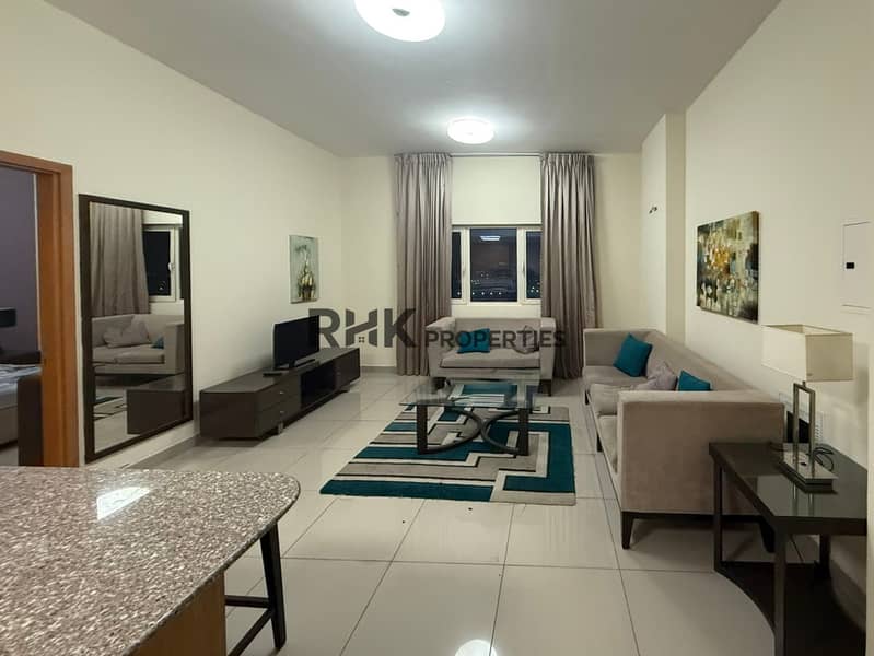 Furnished 1BR apartment living room with teal accents Suburbia Jebel Ali Dubai Furnished 1BR apartment living room with teal accents Suburbia Jebel Ali Dubai