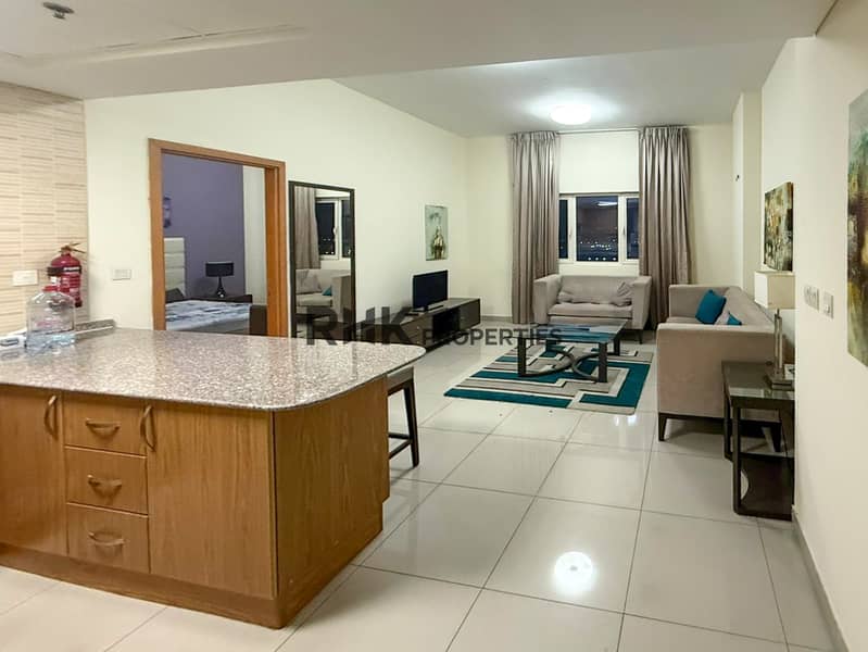3 Open-plan furnished apartment kitchen and living area Suburbia Jebel Ali Dubai