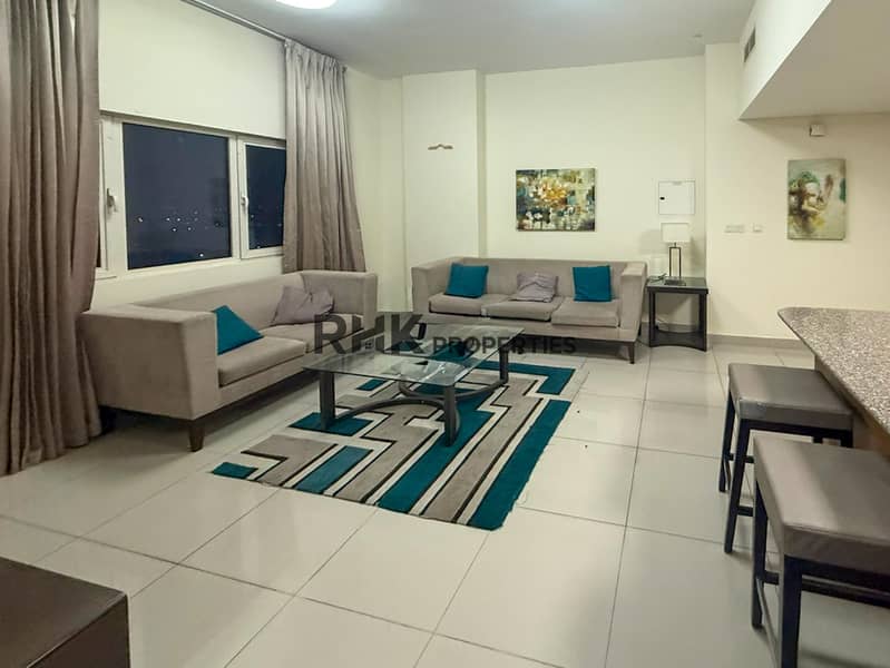 7 Furnished apartment living room two sofas glass coffee table Jebel Ali for rent