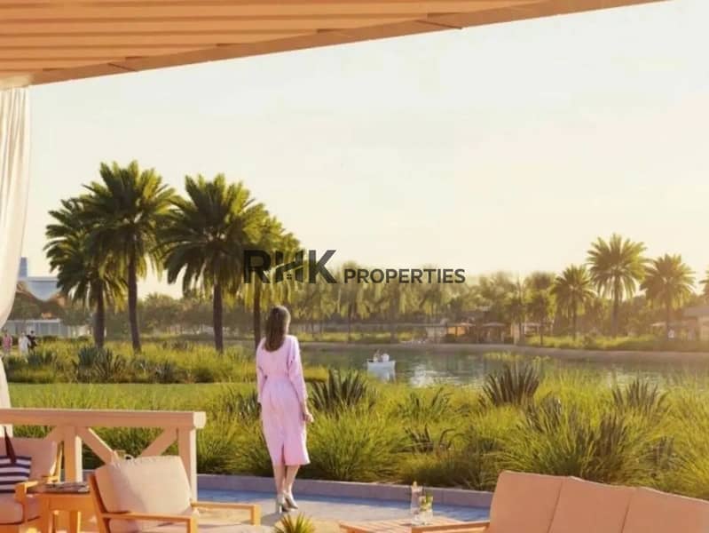 11 Crystal lagoon and sandy beach viewed from a shaded villa terrace at sunset, DAMAC community Dubai