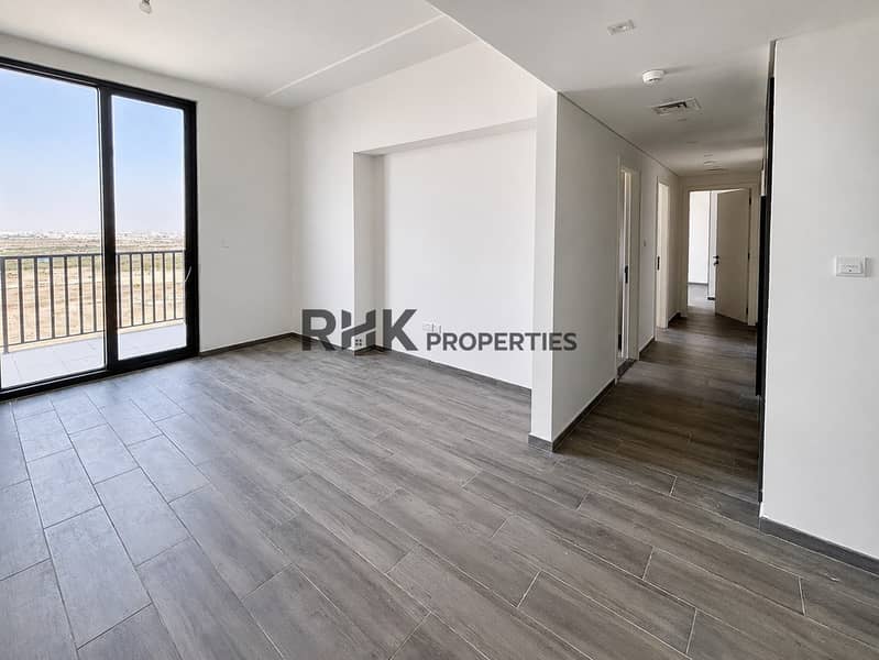 2 Unfurnished Noor 5 two-bedroom apartment living room with balcony access