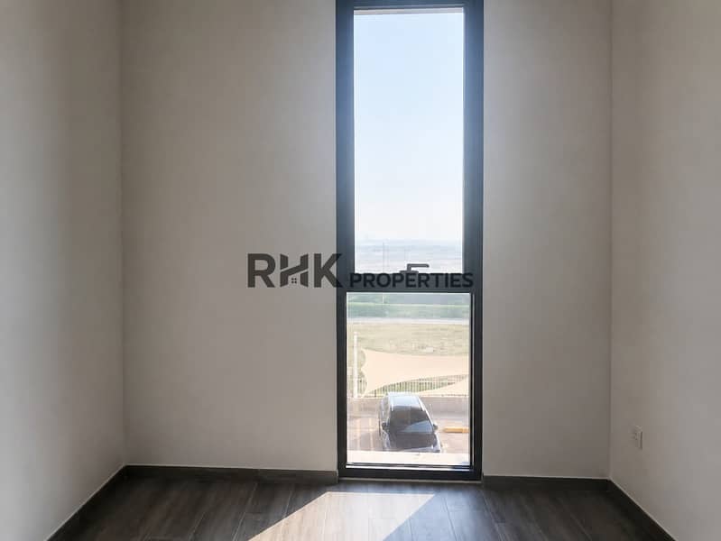 7 Unfurnished bedroom with tall window in Noor 5 Midtown apartment