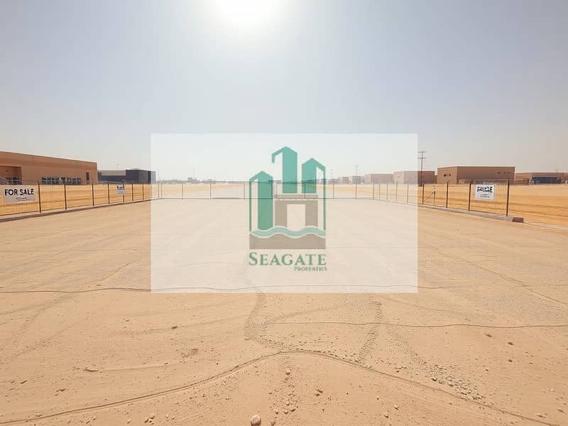 A_high_quality_image_of_a_large_empty_industrial_plot_in_a_desert_like_environment_similar_to_locations_in_the_UAE. _The_plot_is_flat_and_cleared_with_a_smooth_surface_of_packed_sand_and_gravel. _There_are_boundaries_m. jpeg A_high_quality_image_of_a_large_empty_industrial_plot_in_a_desert_like_environment_similar_to_locations_in_the_UAE. _The_plot_is_flat_and_cleared_with_a_smooth_surface_of_packed_sand_and_gravel. _There_are_boundaries_m. jpeg