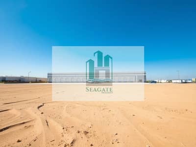 Industrial Land in vendita a Al Sajaa, Sharjah - A_large_clean_empty_plot_of_land_prominently_featured_in_the_foreground_with_the_industrial_warehouse_positioned_in_the_background. _The_plot_showcases_smooth_sandy_terrain_and_is_devoid_of_any_debris. _The_warehou (1). jpeg