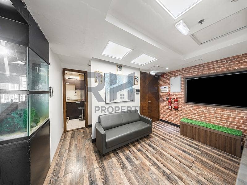 2 Furnished office reception area with brick wall, aquarium and TV in Dubai