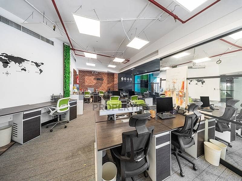 15 Open-plan office space with ergonomic workstations and brick accent wall Dubai