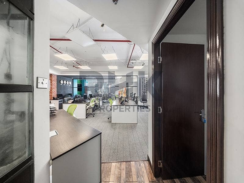 25 Fitted office entrance with open-plan workspace and wooden door in JLT Dubai