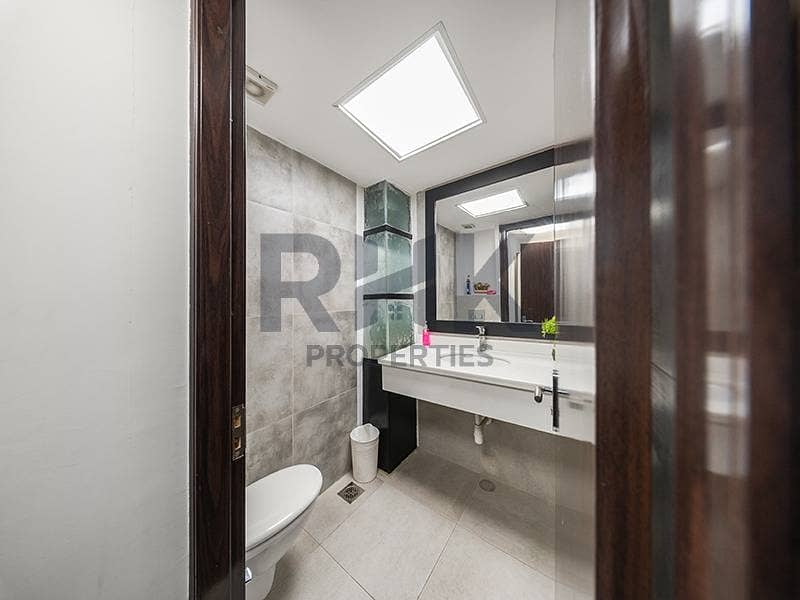 26 Modern office washroom with concrete tiles and vanity in JLT commercial tower Dubai