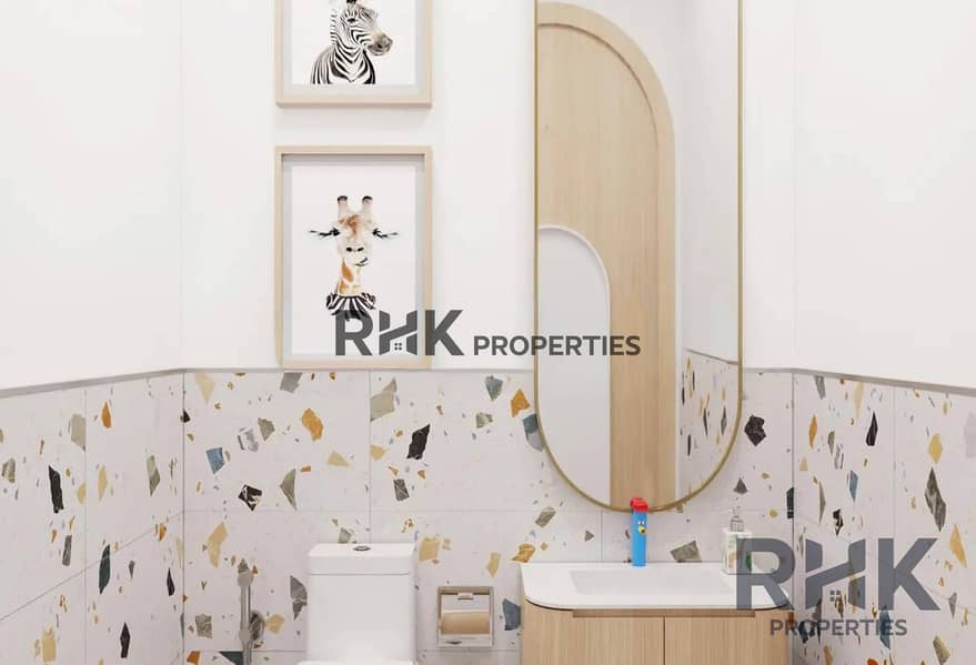 5 Powder room with terrazzo tiling and round mirror in The Portman by Ellington Properties, Dubai