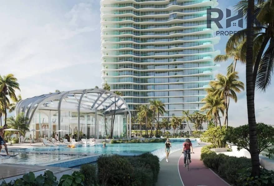 6 Private beach lagoon with sun loungers and Dubai skyline at waterfront apartments