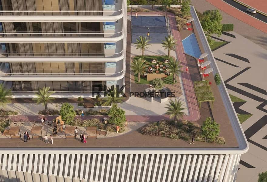 3 Aerial view of residential building podium amenities with tennis court, swimming pool, jogging track, and landscaped gardens in Dubai