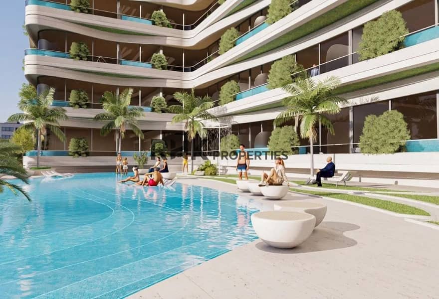 6 Landscaped courtyard pool with palm trees and outdoor seating at luxury apartment complex in Dubai