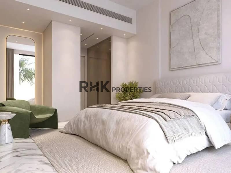 3 Luxury master bedroom with upholstered headboard, green velvet armchair and marble floors in Red Square Dubai