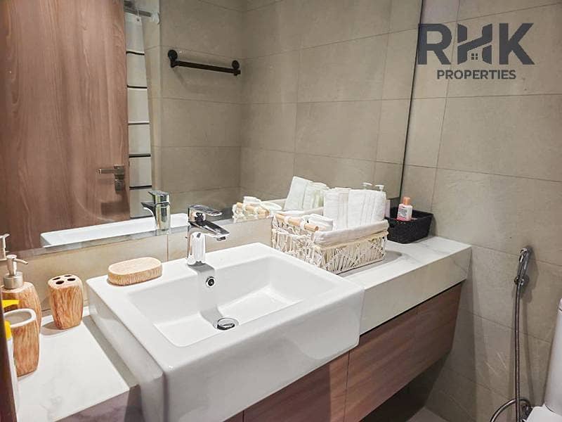 5 Modern bathroom with wood vanity and rectangular basin in Azizi Riviera 41 furnished apartment