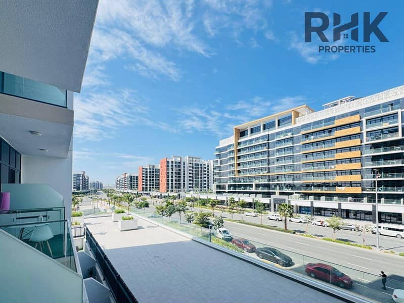 6 Balcony street view of MBR City-style boulevard lined with mid-rise apartment buildings in Dubai