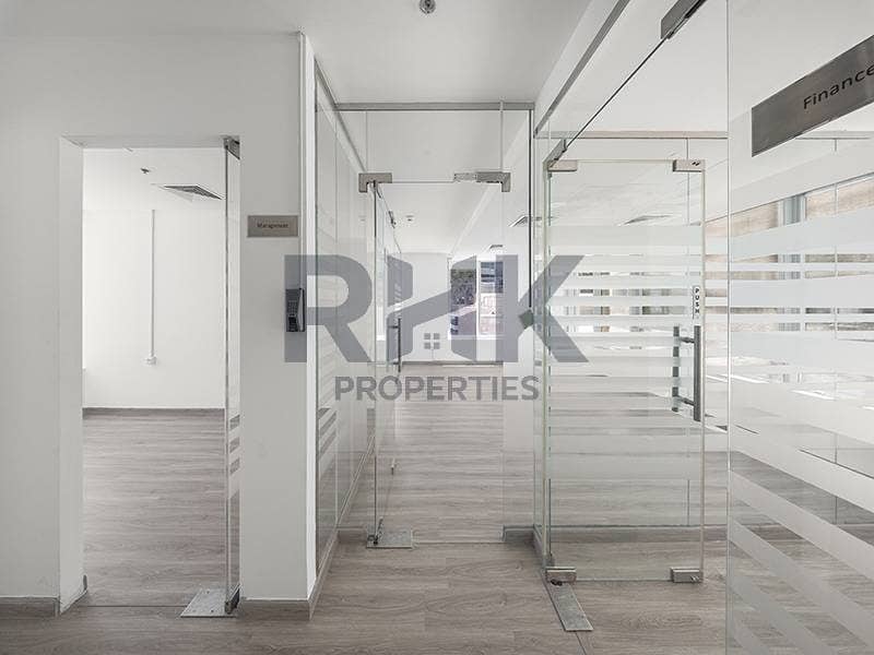 3 Fitted office corridor in Ontario Tower Business Bay with Management and Finance cabins behind frosted glass partitions and wooden flooring