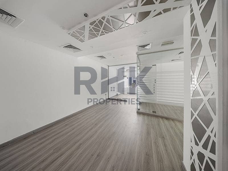 9 Bright office room in Ontario Tower Business Bay with decorative lattice partition, glass wall and grey laminate flooring for rent