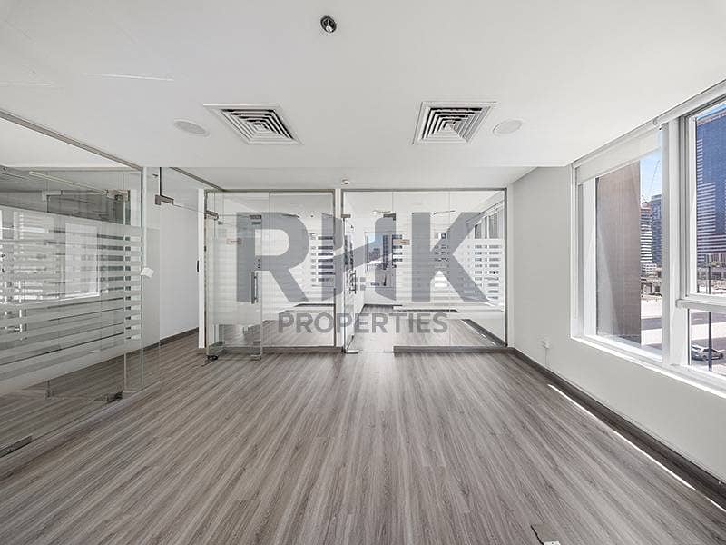 10 Corner fitted office in Ontario Tower Business Bay with panoramic tower views, glass-partitioned cabins and wood-look flooring