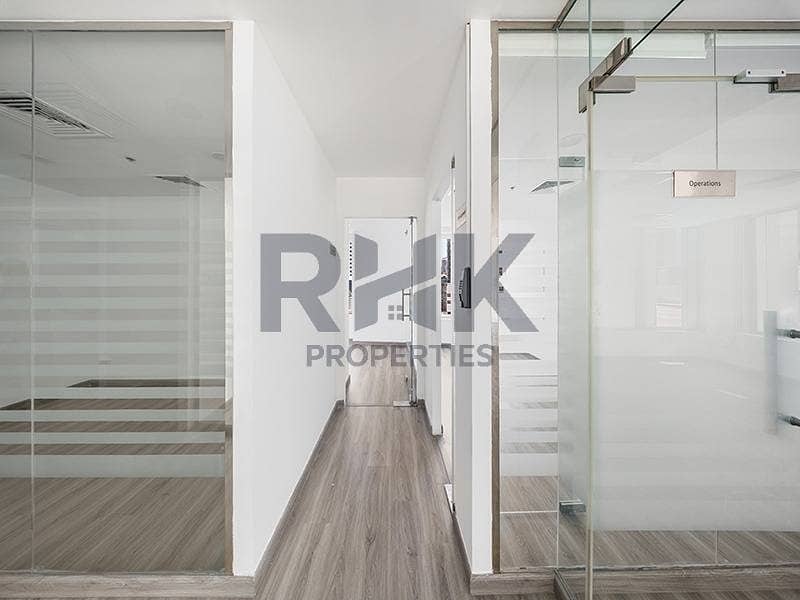 12 Fitted office hallway in Ontario Tower Business Bay with Operations room signage, glass partitions and grey wood-effect flooring
