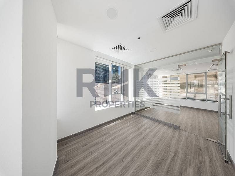 13 Private office cabin in Ontario Tower Business Bay with window view, glass door partition and laminate wood flooring for rent