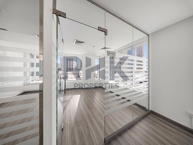 14 Glass-partitioned corner office in Ontario Tower Business Bay with meeting room, Dubai skyline views and frosted stripe glazing