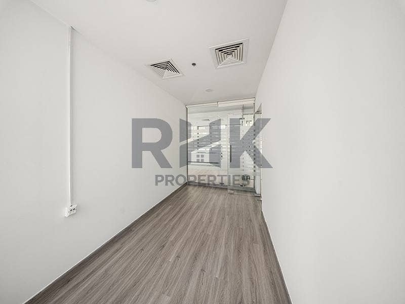 15 Compact private office room in Ontario Tower Business Bay with glass partition wall and grey laminate flooring, ready to move in