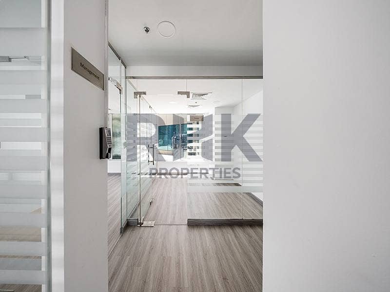16 Management office entrance in Ontario Tower Business Bay with glazed partitions, wall phone point and wood-look laminate flooring