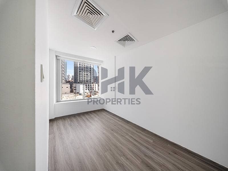 17 Bright private office room in Ontario Tower Business Bay with corner window, tower views and grey laminate wood flooring for rent