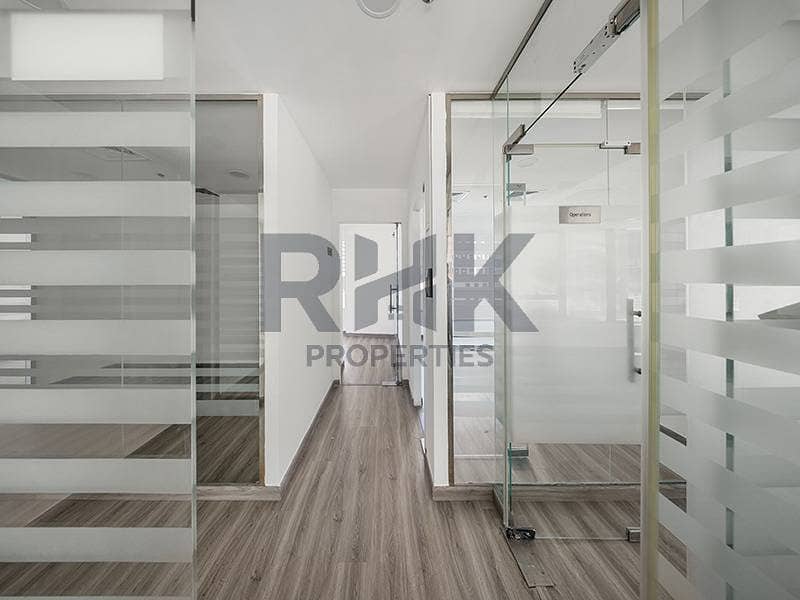 18 Fitted office corridor in Ontario Tower Business Bay with Operations cabin, frosted glass partitions and laminate wood flooring
