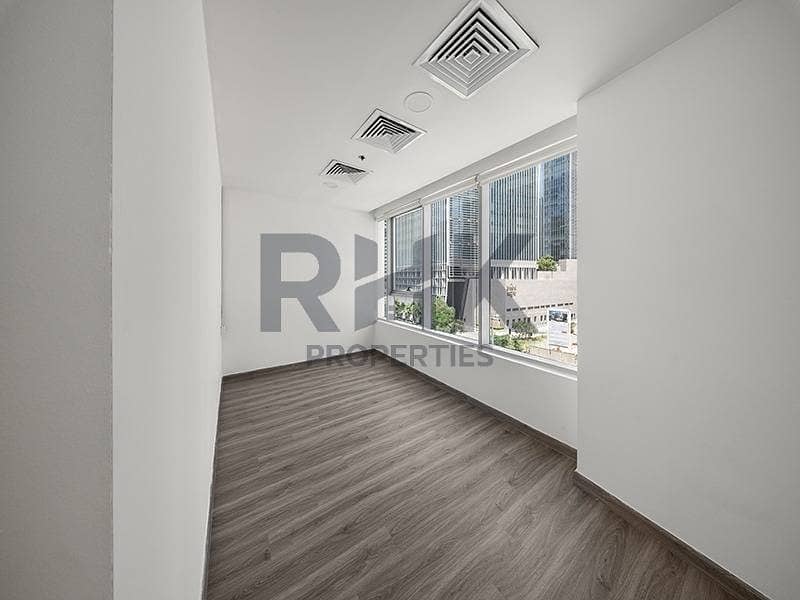 20 Corner office cabin in Ontario Tower Business Bay with wraparound windows, skyline views and laminate flooring available for rent