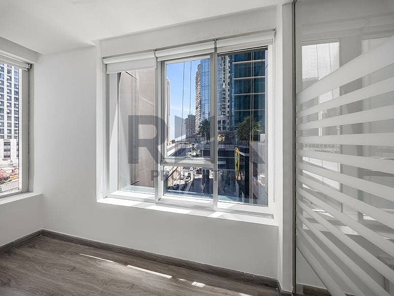 22 Private office room in Ontario Tower Business Bay with sliding windows, street tower views and frosted glass partition wall for ren