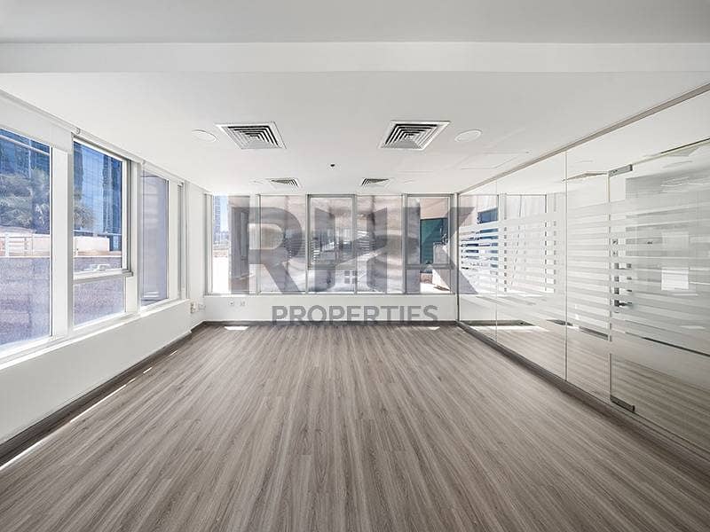 27 Bright open-plan office in Ontario Tower Business Bay with corner windows, glass partition wall and grey laminate wood flooring for rent