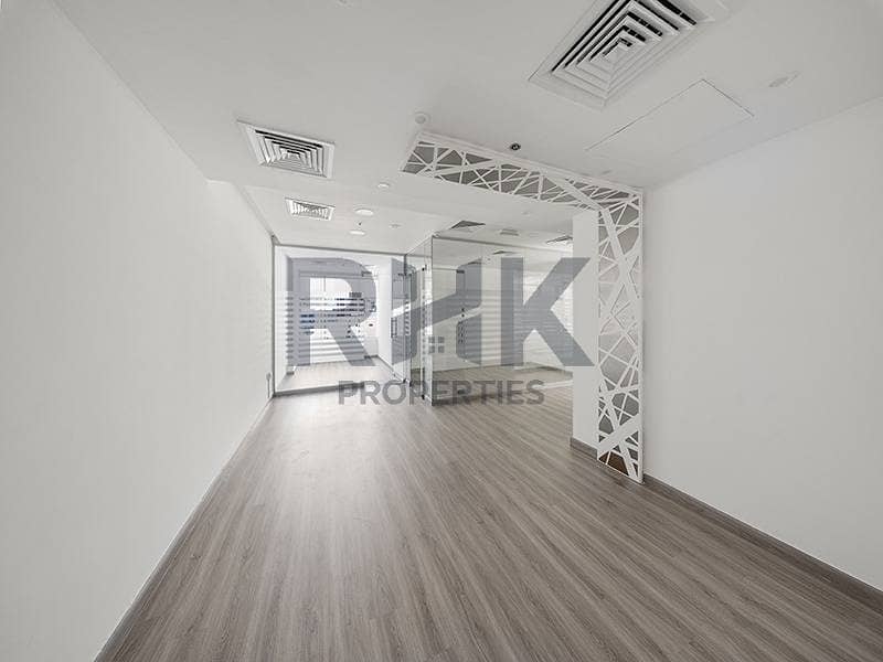 28 Fitted office space in Ontario Tower Business Bay with decorative lattice column, glass partition and wood-look laminate flooring