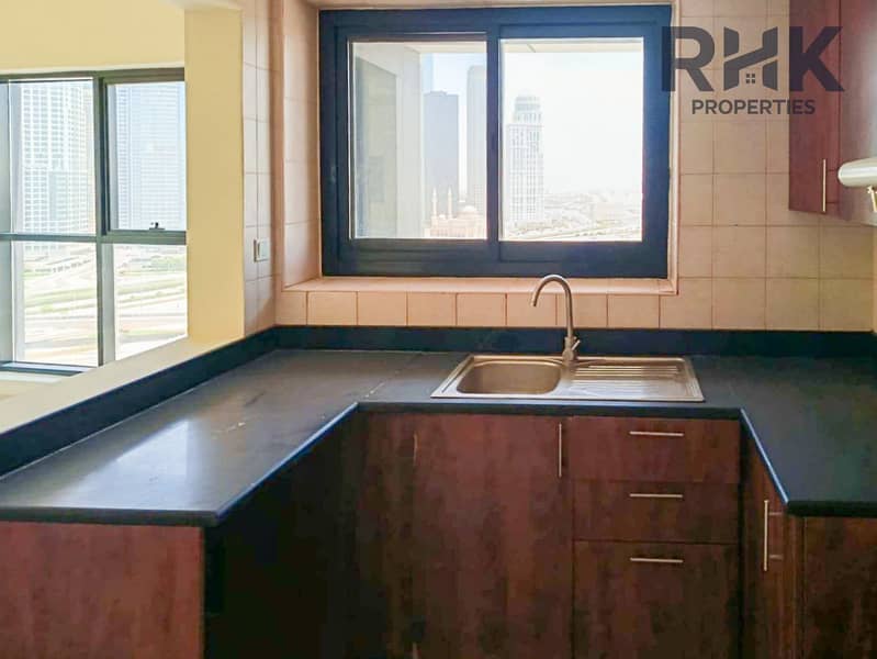 9 Fitted kitchen with sink, wooden cabinets and skyline window in JLT Dubai apartment