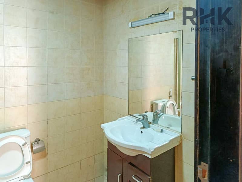 11 Bathroom with vanity unit, mirror and storage in JLT Dubai residential apartment