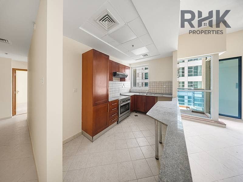3 Semi-open kitchen with wooden cabinets in Dubai Marina apartment