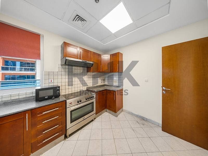 9 Closed kitchen with wooden cabinets and gas cooker in Dubai Marina apartment