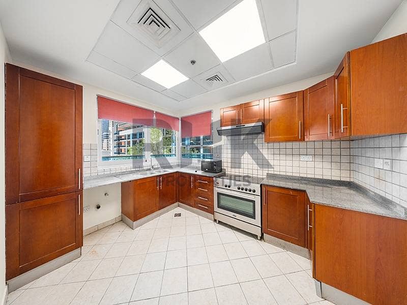 11 Large closed kitchen with wooden cabinetry and storage in Dubai Marina apartment
