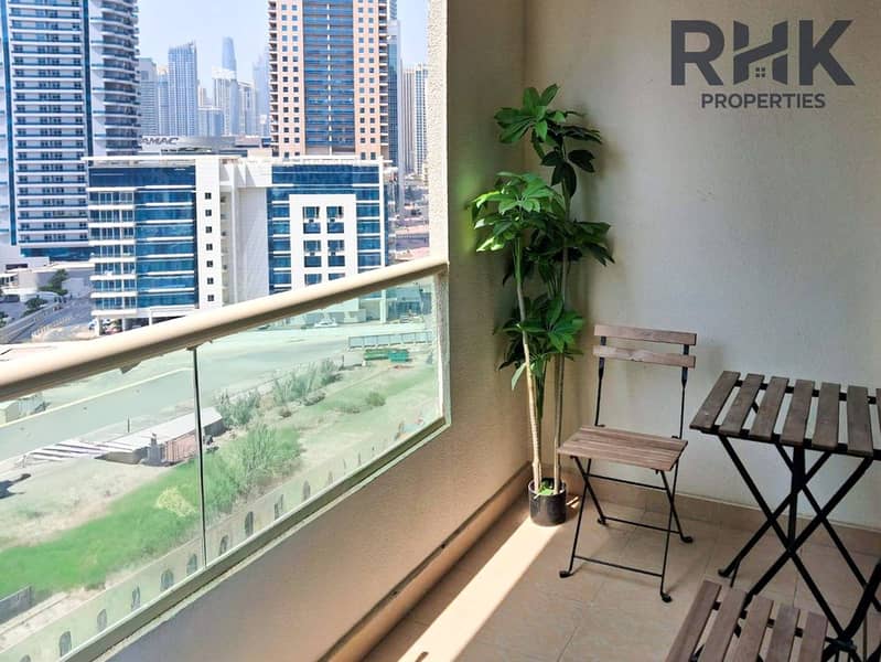 4 Balcony with bistro seating and Dubai Marina tower views, furnished 1-bed apartment