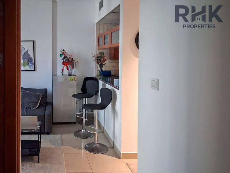 10 Entrance hallway with framed art leading to living room, Dubai Marina 1-bed apartmen