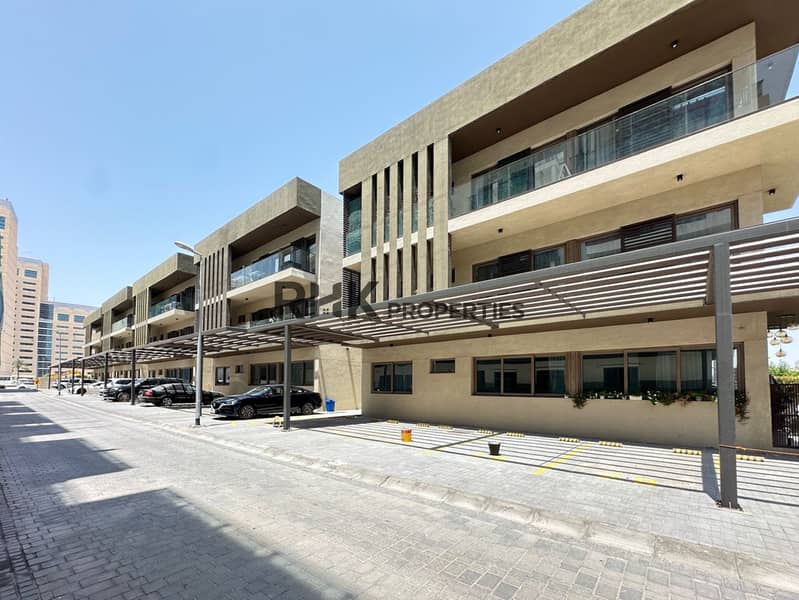 15 Low-rise residential building with covered parking and glass balconies in Jumeirah Village Circle Dubai