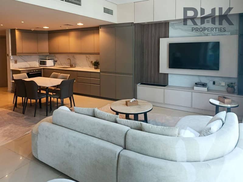 4 Modern fitted kitchen and lounge with wall-mounted TV in furnished Marina apartment Dubai